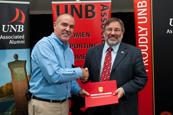 Mr. Larry Hachey, President of the UNB Associated Alumni, presents Dr. Thierry Chopin with the Simply the Best Award